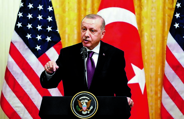 FILE PHOTO: Turkish President Tayyip Erdogan answers questions during a joint news conference with U.S. President Donald Trump at the White House in Washington